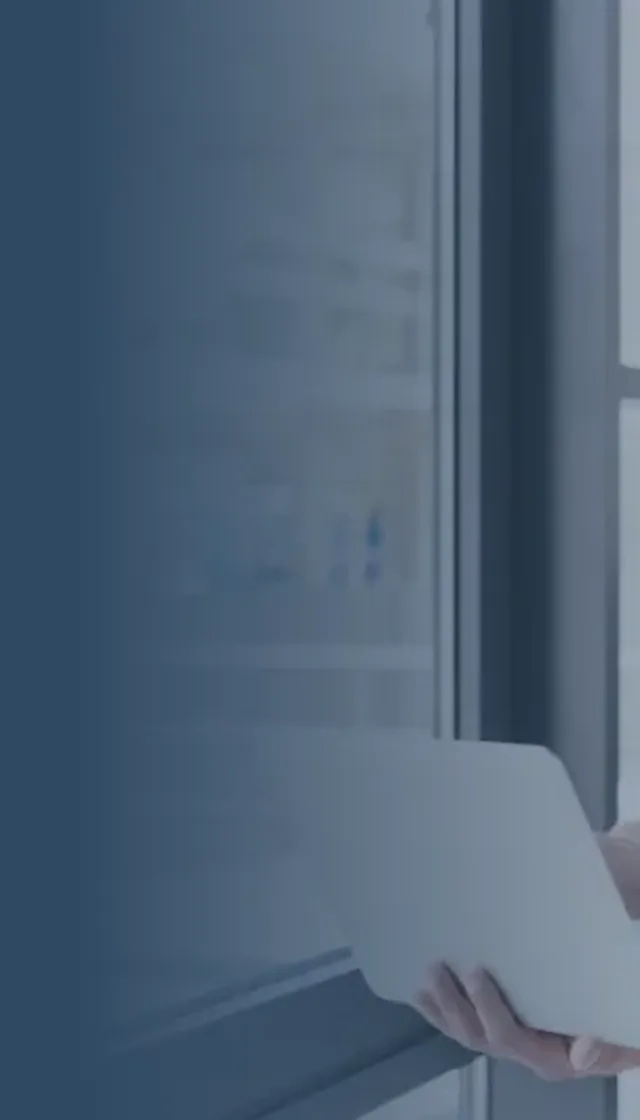 Colleague on laptop in office smiling