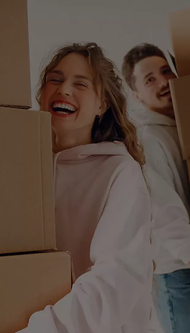 Happy couple moving boxes