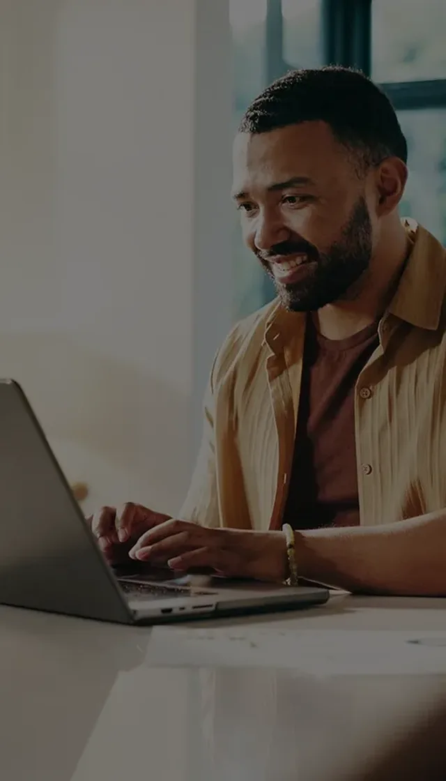 Happy man using laptop