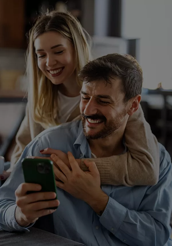 Couple using smartphone to buy life insurance for parents