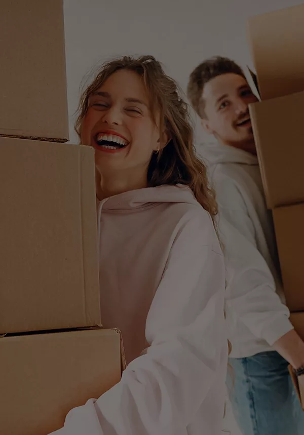 Happy couple moving boxes