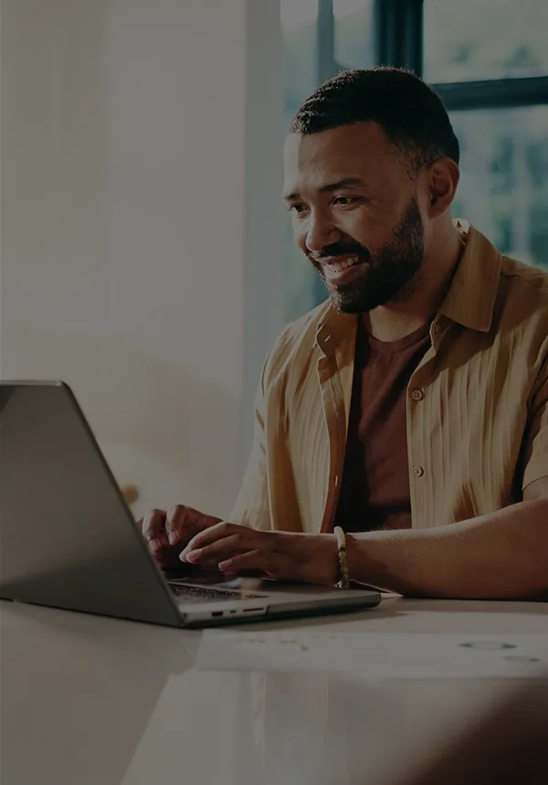 Happy man using laptop