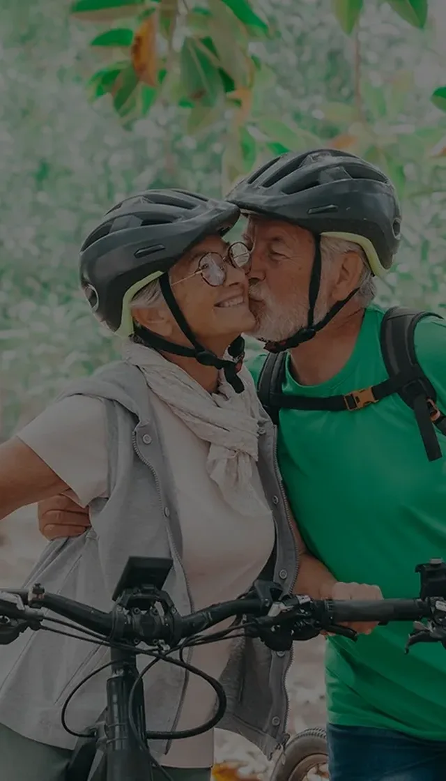 Kissing senior couple on cycle ride