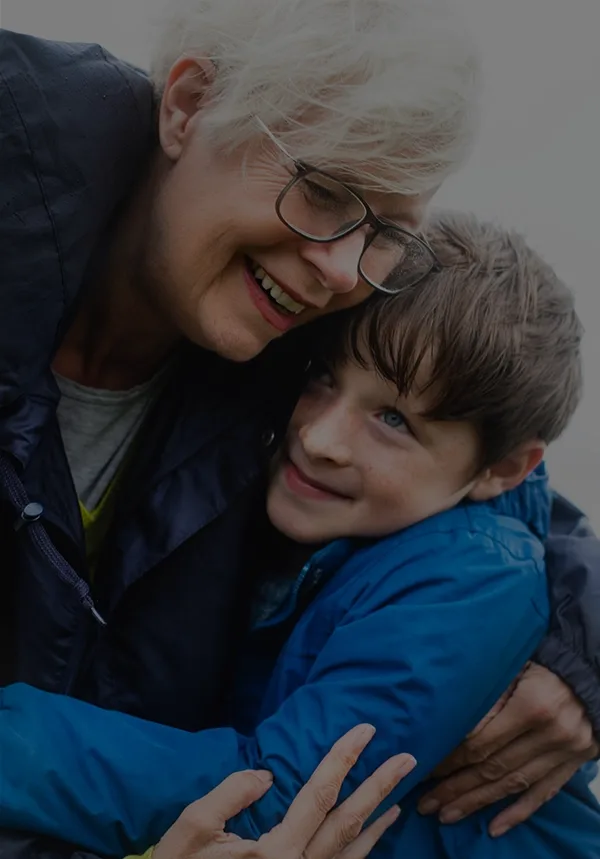 Loving senior cuddling grandson